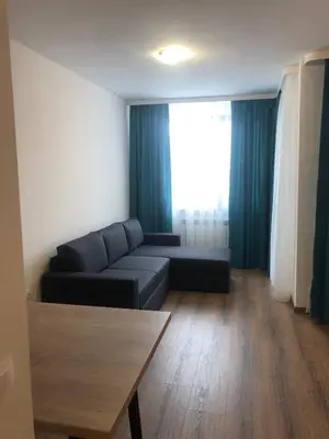 a living room with a couch and a table at Private studio B27 in Borovets Gardens in Borovets