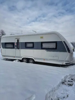 a trailer parked in a parking lot in the snow at Caravan for rent in Bansko