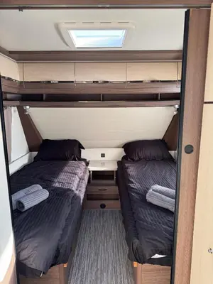 two beds in the middle of a small room at Caravan for rent in Bansko
