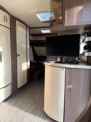 a room with a desk with a computer monitor on it at Caravan for rent in Bansko