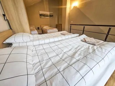 a large white bed sitting in a bedroom at Vista Apartment in Borovets