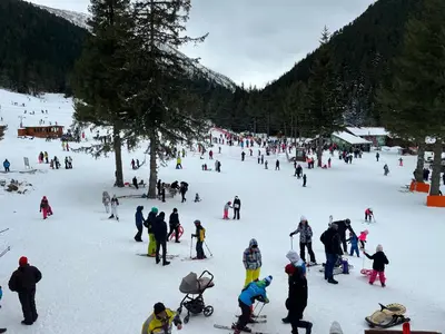 a large group of people on a ski slope at The Cube in Samokov