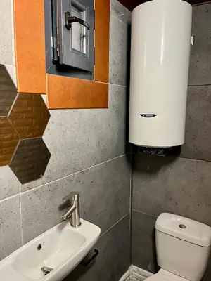 a bathroom with a toilet and a sink at The Cube in Samokov