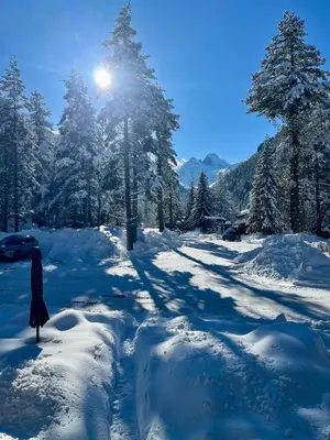 a person walking down a snow covered road at The Cube in Samokov