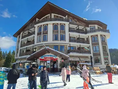 a group of people standing in front of a building at Студио Студенец in Pamporovo