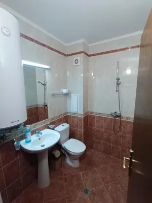 a bathroom with a toilet and a sink and a shower at Студио Студенец in Pamporovo