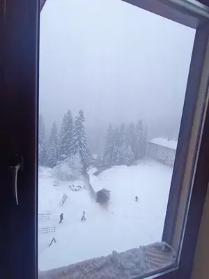 a view from a window of a ski slope in the snow at Студио Студенец in Pamporovo