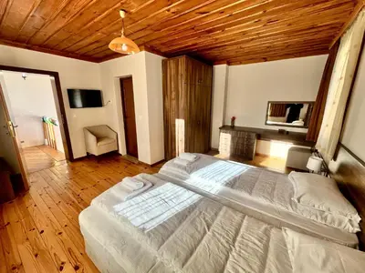 a large bed in a bedroom with a wooden ceiling at Къща за гости в село Проглед - комплекс Божидарица 4А in Progled