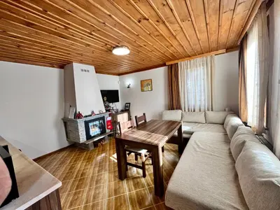 a living room with a couch and a wooden ceiling at Къща за гости в село Проглед - комплекс Божидарица 4А in Progled