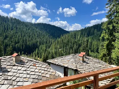a view of the mountains from the roofs of houses at Къща за гости в село Проглед - комплекс Божидарица 4А in Progled