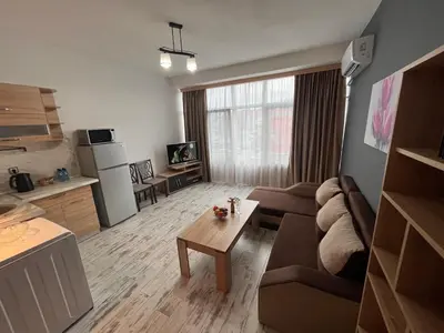 a living room with a couch and a table at Апартамент Аксел in Panagyurishte