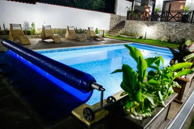 a swimming pool with a blue light in a house at Einstein House & Spa in Marchevo