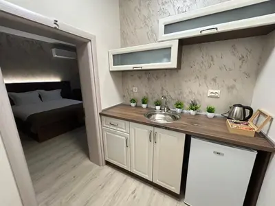 a kitchen with a sink and a bed in a room at Алтъна Калофер in Kalofer