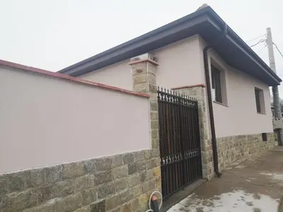 a house with a fence and a gate at Алтъна Калофер in Kalofer