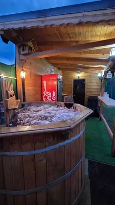 a large wooden bar with a glass of wine at Guest house Belitsa in Semkovo