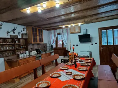 a dining room with a table in a kitchen at Марковата Къща in Madzhare