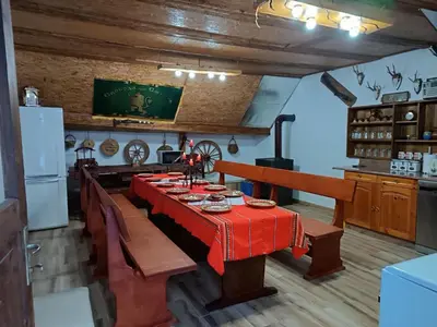 a dining room with a red table in a kitchen at Марковата Къща in Madzhare
