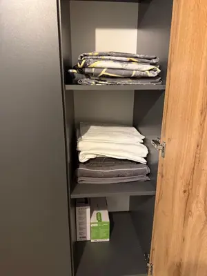 a closet with a stack of folded towels at Cozy Homes Slivnitsa Studios in Sofia