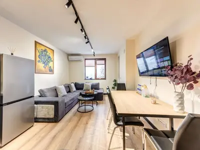 a living room with a couch and a table at 1BD Mountain Getaway in Pamporovo with Parking By Flat Mаnager in Pamporovo