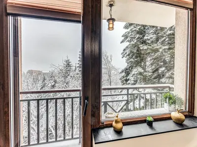 a window with a view of the snow covered trees at 1BD Mountain Getaway in Pamporovo with Parking By Flat Mаnager in Pamporovo