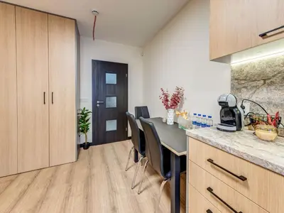 a kitchen with a table and chairs in a room at Alpine Glow Studio with Parking Pamporovo in Pamporovo