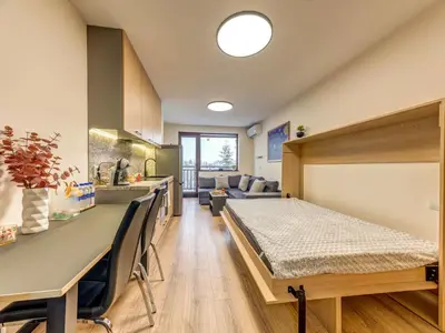 a hospital room with a bed and a kitchen at Alpine Glow Studio with Parking Pamporovo in Pamporovo