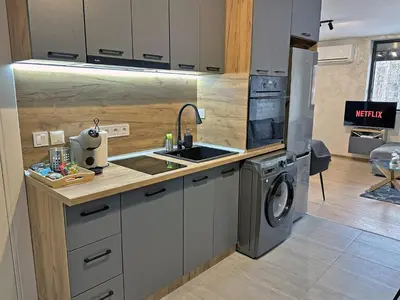 a kitchen with a sink and a washing machine at New! Park Lane Bansko Residences in Bansko