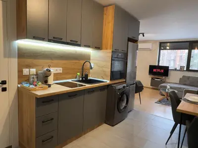 a kitchen with a sink and a washing machine at New! Park Lane Bansko Residences in Bansko