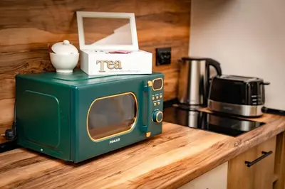 a green microwave sitting on top of a kitchen counter at Bansko Peak Apartments 102 in Bansko