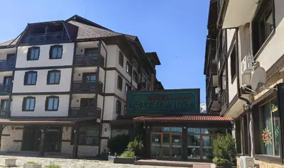 a building with a sign for a hotel at Bansko Peak Apartments 102 in Bansko