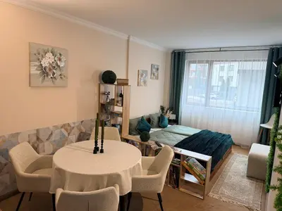 a living room with a bed and a table and chairs at Bansko Peak Apartments 102 in Bansko