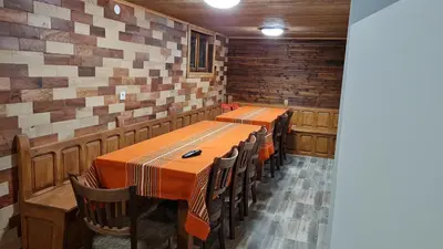 a dining room with a long table and chairs at Guest House Zlatniyat Telets in Koprivshtitsa