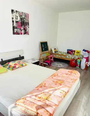 a bedroom with two twin beds and a table at Cozy apartment kids friendly in Sofia