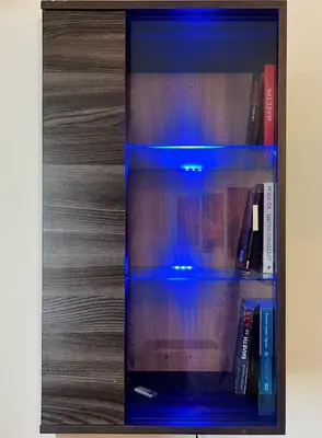 a glass book shelf with books on it at Cozy apartment kids friendly in Sofia