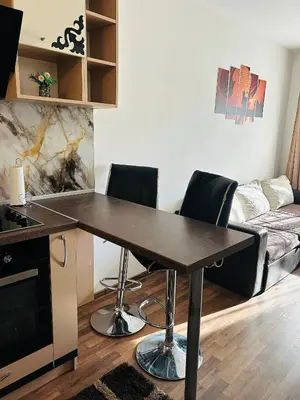 a kitchen with a table and chairs in a living room at Cozy apartment kids friendly in Sofia