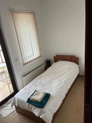 a bedroom with a bed with a towel on it at Villa Dreams in Golf Club Ibar in Dolna Banya
