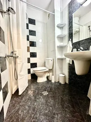 a bathroom with a toilet and a sink at Ikigai Living - Cozy Studio in Studentski Grad in Sofia