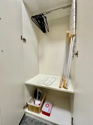 a small closet with white walls and white shelves at Ikigai Living - Cozy Studio in Studentski Grad in Sofia