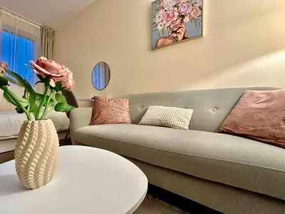 a living room with a couch and a table at Ikigai Living - Cozy Studio in Studentski Grad in Sofia