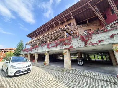 a white car parked in front of a building at 3 bedroom Penthouse only 700 meters from Ski Lift in Bansko