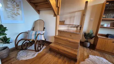 a room with a stair case and a chair in a room at 3 bedroom Penthouse only 700 meters from Ski Lift in Bansko