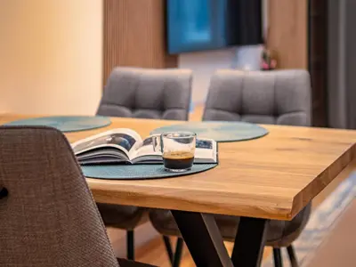 a cup of coffee and a book on a table at Stylish New High-End 3BR Apt on Vitoshka Blvd in Sofia