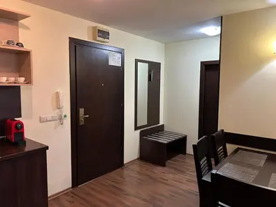 a room with a door and a table and a mirror at Частен апартамент Банско in Bansko