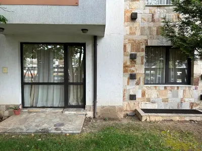 an entrance to a building with a door and windows at Частен апартамент Банско in Bansko