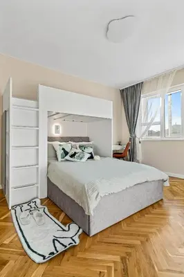 a white bedroom with a large bed and a desk at Kapana - a 106m2 Flat right on the Pedestrian Street in Plovdiv