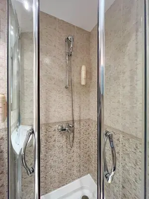 a shower with a glass door in a bathroom at Bansko Peak Apartments 106 in Bansko