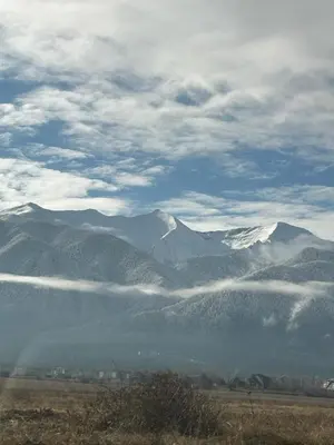 a view of a mountain range with snow capped mountains at Green Elephant in Razlog