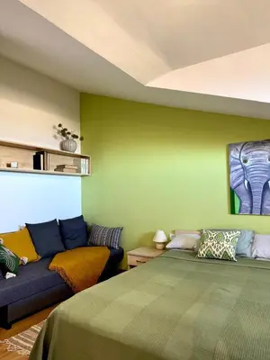 a living room with a couch and a bed at Green Elephant in Razlog