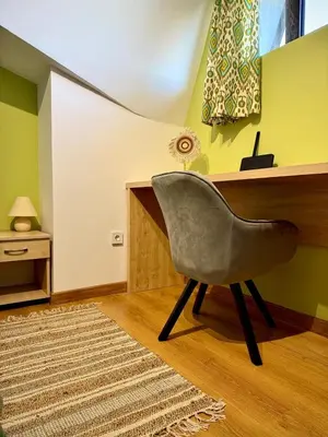 a chair sitting in a room with a desk at Green Elephant in Razlog