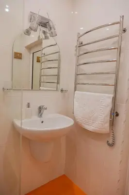 a bathroom with a sink and a mirror at Апартамент в центъра на Хисаря in Hisarya